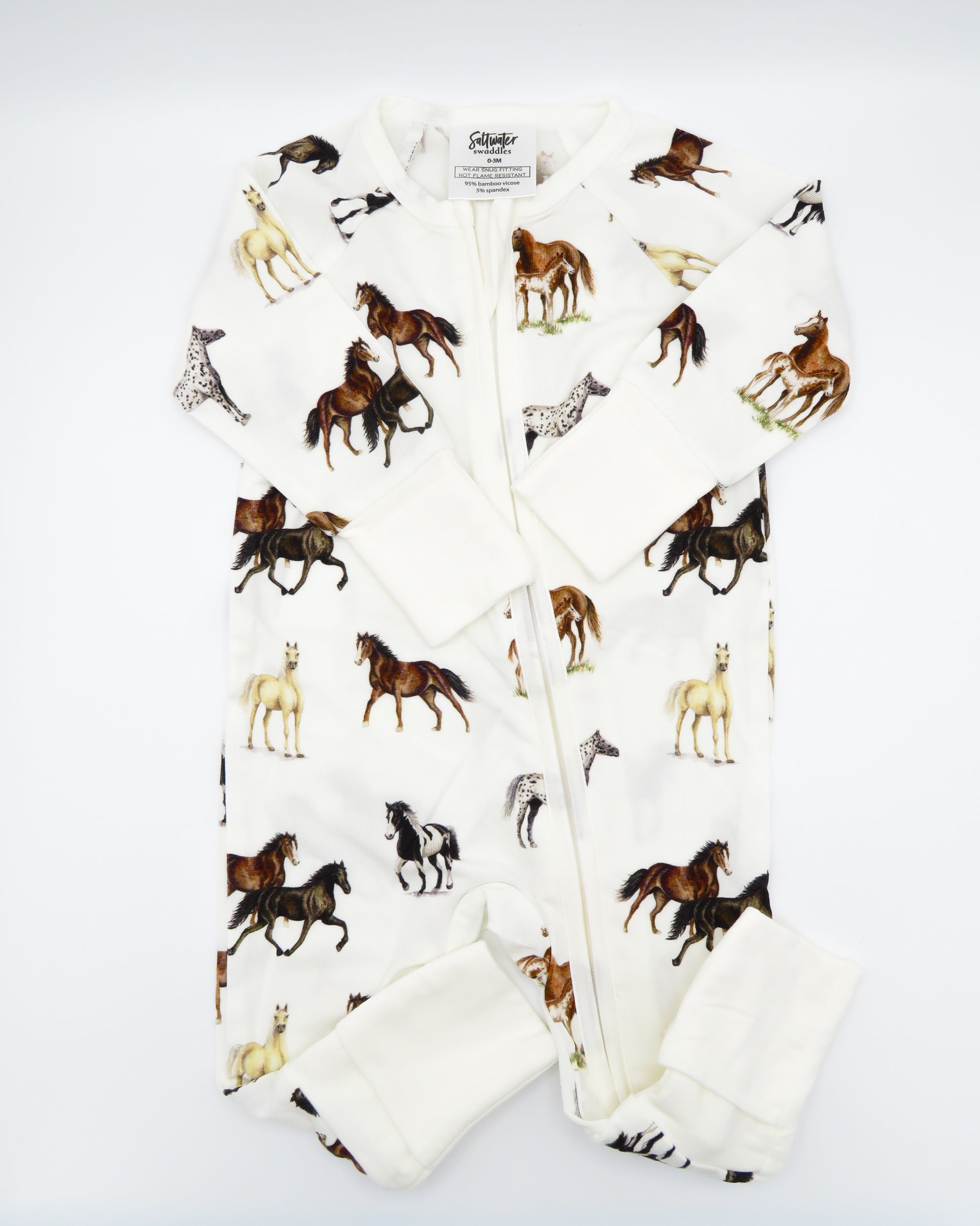 Harbor Horses convertible baby zip footie pajamas with hand-painted horse designs in vibrant colors on white 100% bamboo fabric, featuring fold-over feet for comfort and convertible wear. A perfect addition to your baby essentials.