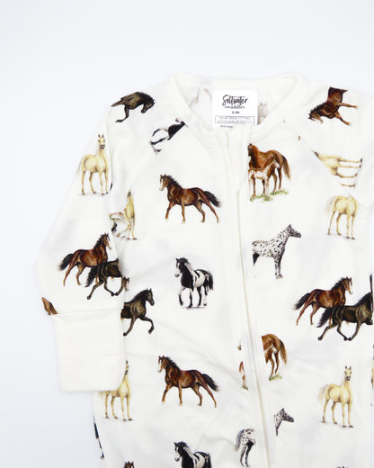 Harbor Horses convertible baby zip footie pajamas with hand-painted horse designs in vibrant colors on white 100% bamboo fabric, featuring fold-over feet for comfort and convertible wear. A perfect addition to your baby essentials.