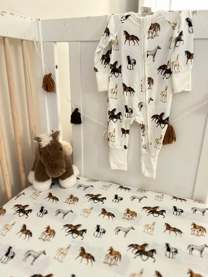 Harbor Horses convertible baby zip footie pajamas with hand-painted horse designs in vibrant colors on white 100% bamboo fabric, featuring fold-over feet for comfort and convertible wear. A perfect addition to your baby essentials.