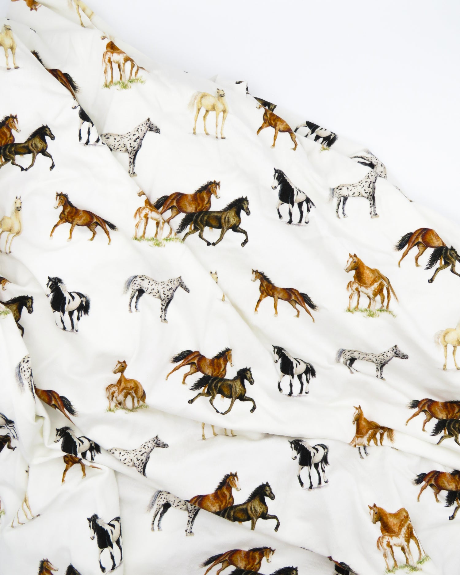 Our Harbor Horses” crib sheet featuring hand-painted, colorful horses printed on soft white 100% cotton jersey, fitted for cribs or toddler beds, perfect for a horse-themed nursery.