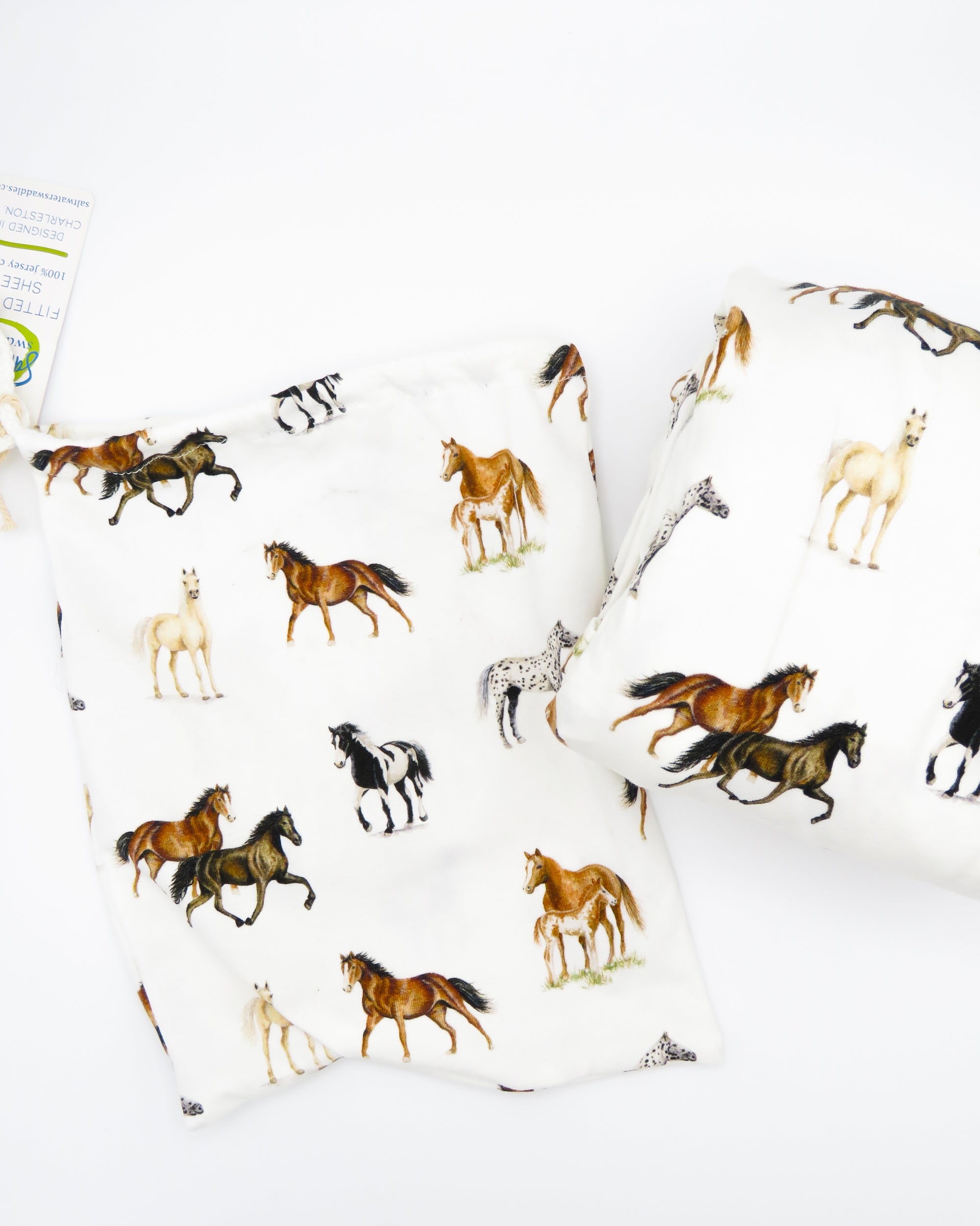 Our Harbor Horses” crib sheet featuring hand-painted, colorful horses printed on soft white 100% cotton jersey, fitted for cribs or toddler beds, perfect for a horse-themed nursery.