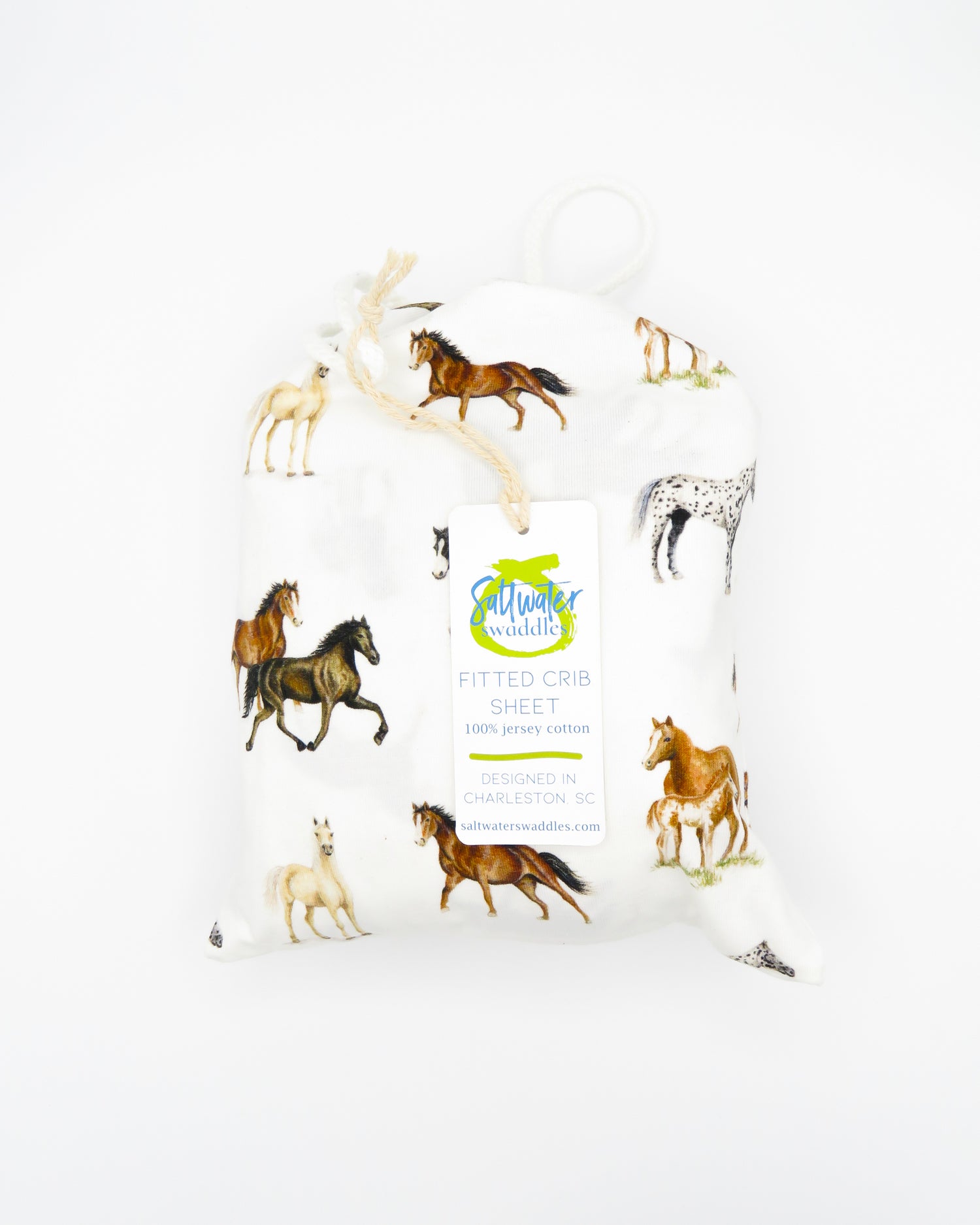 Our Harbor Horses crib sheet featuring hand-painted, colorful horses printed on soft white 100% cotton jersey, fitted for cribs or toddler beds, perfect for a horse-themed nursery.