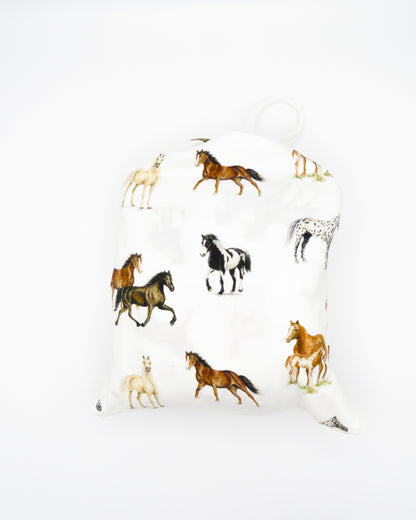 Our Harbor Horses” crib sheet featuring hand-painted, colorful horses printed on soft white 100% cotton jersey, fitted for cribs or toddler beds, perfect for a horse-themed nursery.