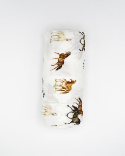 Harbor Horse swaddle with painted horse designs, made of soft white 30% organic cotton and 70% bamboo, perfect for wrapping a newborn and adding to a hospital bag.