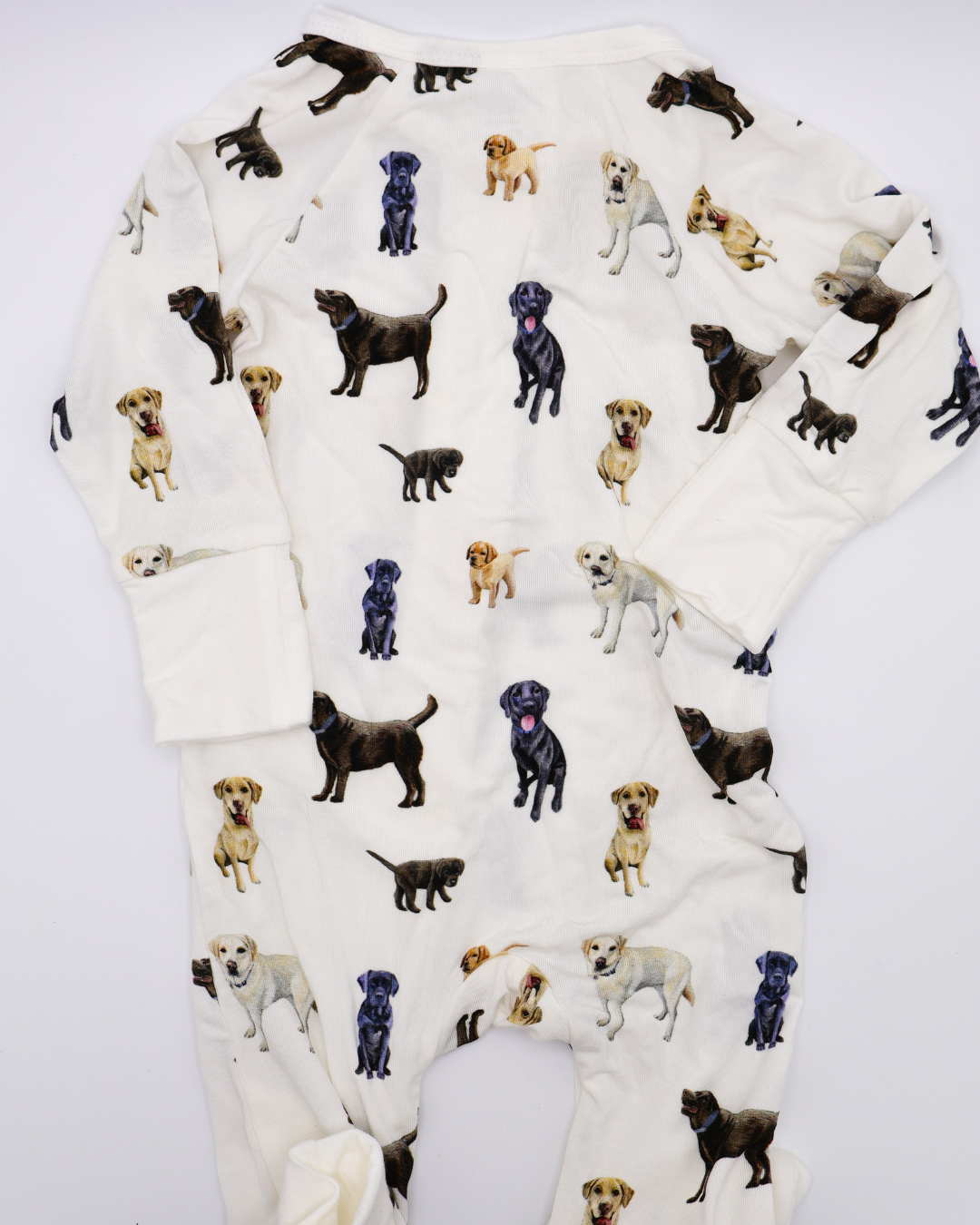 A convertible zip footies for babies, featuring an all-over print of black, chocolate and yellow labs. Displayed flat on a white background.