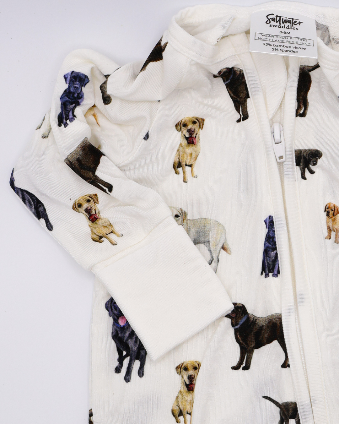 A convertible zip footies for babies, featuring an all-over print of black, chocolate and yellow labs. Displayed flat on a white background.
