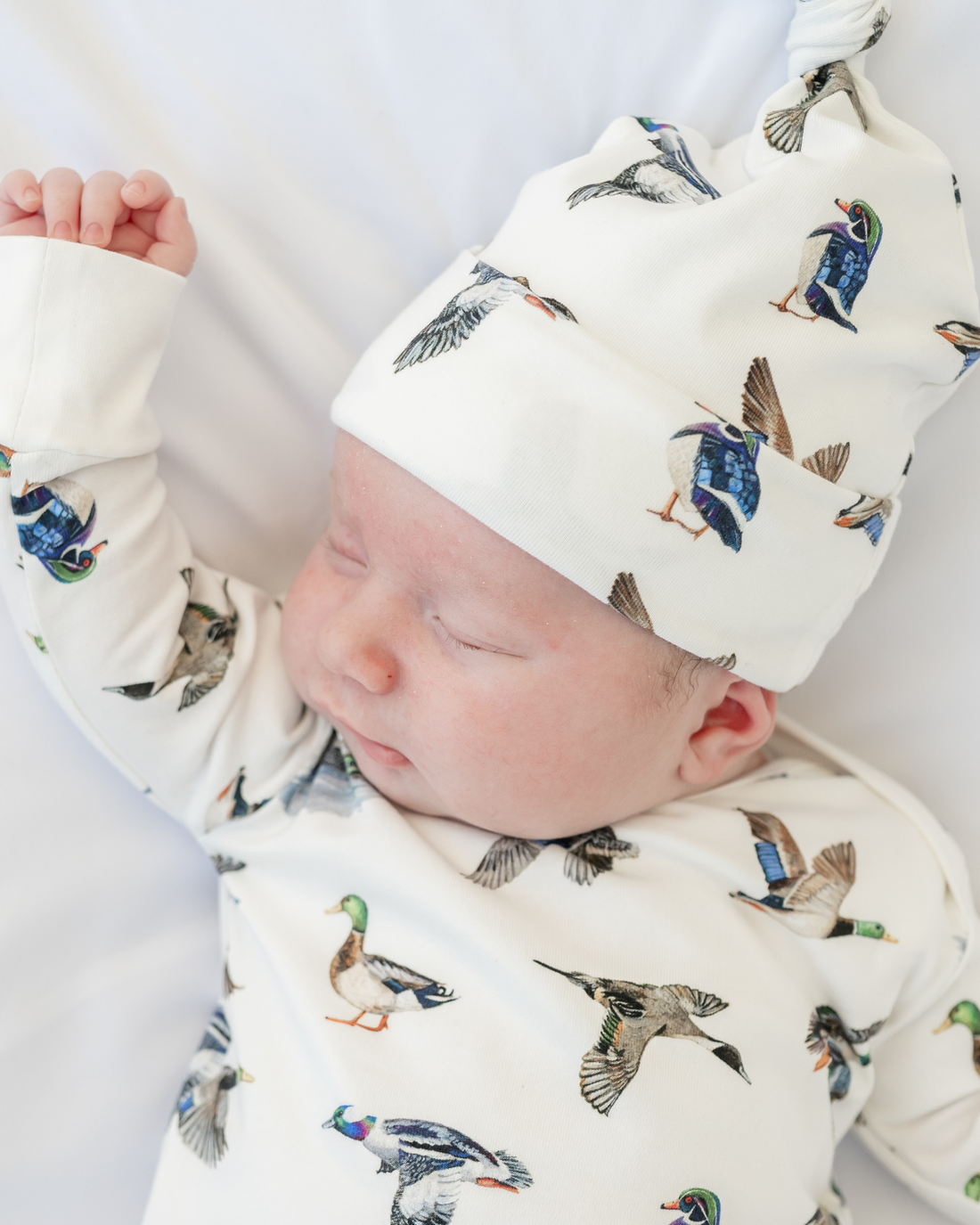Unisex duck-print convertible zip footies for babies, designed for comfort and breathability.