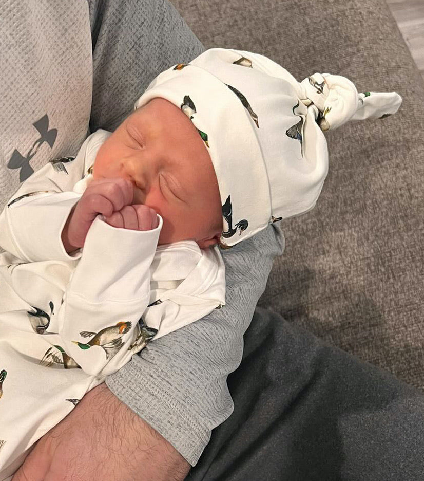 Newborn hat featuring a playful diving ducks print on a soft cotton fabric