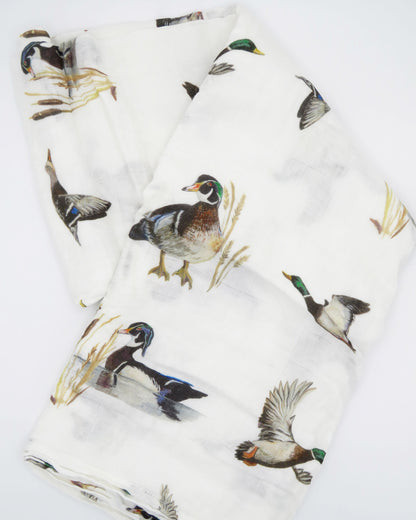 Vibrant pattern of diving ducks on a soft swaddle, perfect for wrapping newborns in style and comfort