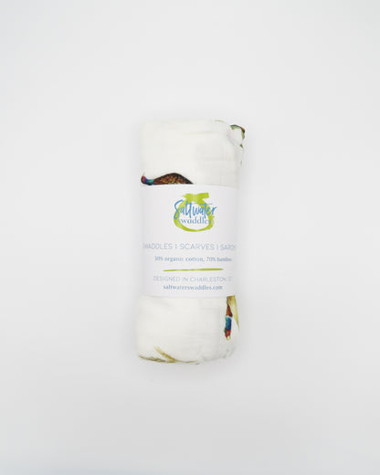 Pheasant and Quail Print Baby Swaddle – Vibrant nature-inspired design made from organic white cotton and bamboo, cozy and soft, rolled and displayed flat on a white background.