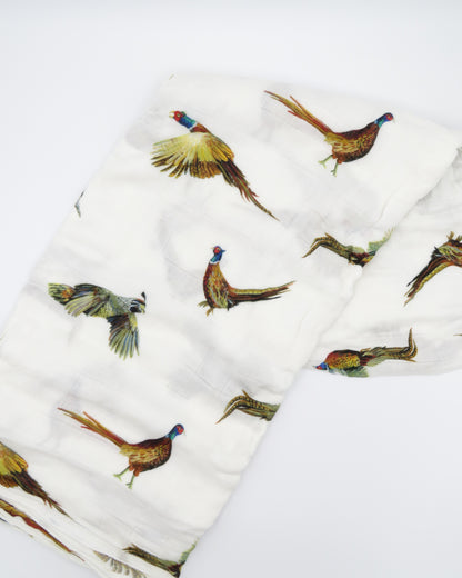 Pheasant and Quail Print Baby Swaddle – Vibrant nature-inspired design made from organic white cotton and bamboo, cozy and soft, folded and displayed flat on a white background.