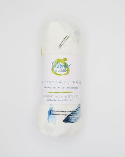 Southern Storks Baby Swaddle Blanket for Newborns. Rolled and displayed on a white background. A perfect addition to your hospital bag.