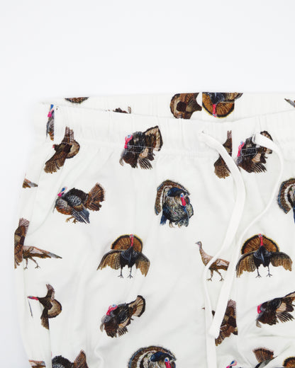 Turkey Trot adult pajama pants in soft white bamboo spandex with a turkey print, cozy and stretchy for loungewear or sleepwear. Displayed flat on a white background.