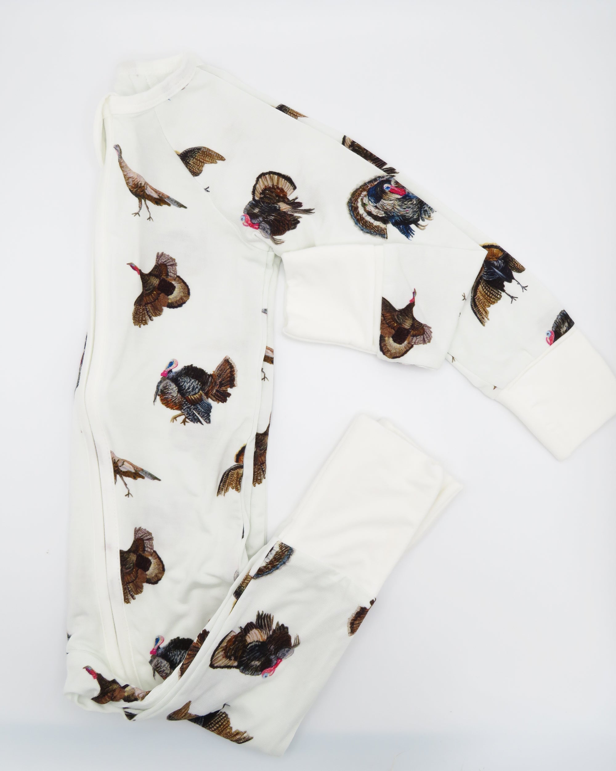 Convertible zip baby footie in festive turkey trot pattern for boys and girls. Printed on soft white fabric, Perfect for indoors and outdoors.
