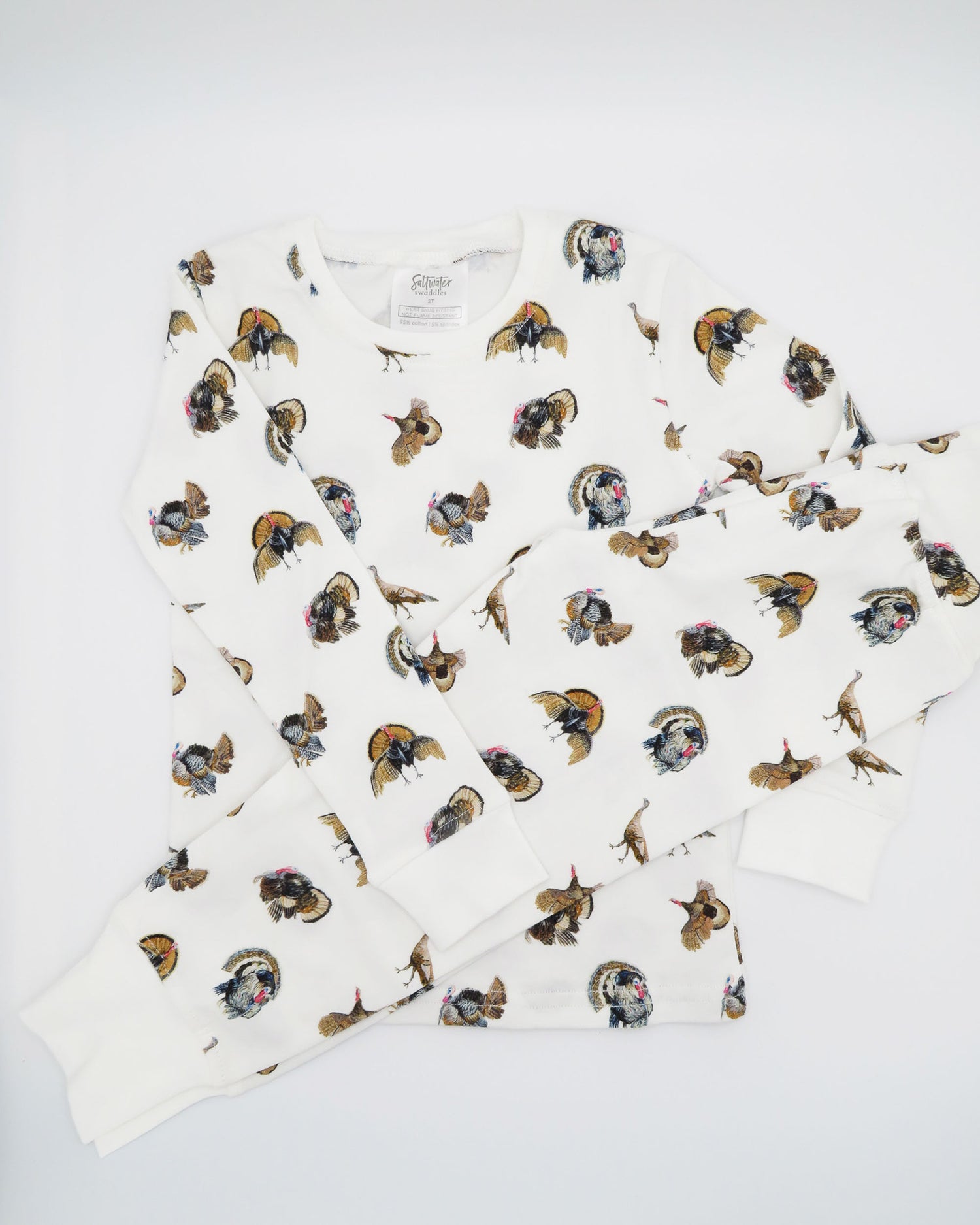 Turkey Trot print pajama for kids, high-quality, cozy, and soft. Perfect for sleepwear or loungewear indoors and outdoors, printed on soft white fabric. Displayed flat on white background.