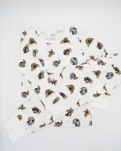 Turkey Trot print pajama for kids, high-quality, cozy, and soft. Perfect for sleepwear or loungewear indoors and outdoors, printed on soft white fabric. Displayed flat on white background.