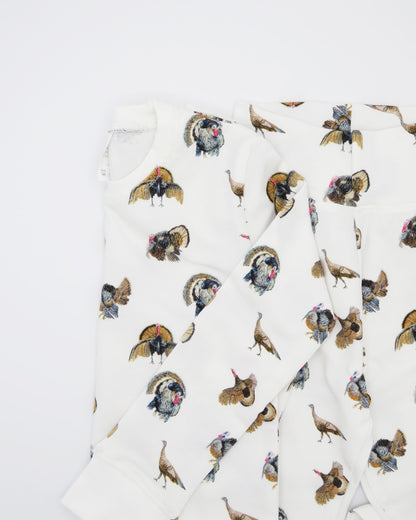 Turkey Trot print pajama for kids, high-quality, cozy, and soft. Perfect for sleepwear or loungewear indoors and outdoors, printed on soft white fabric. Displayed flat on white background.