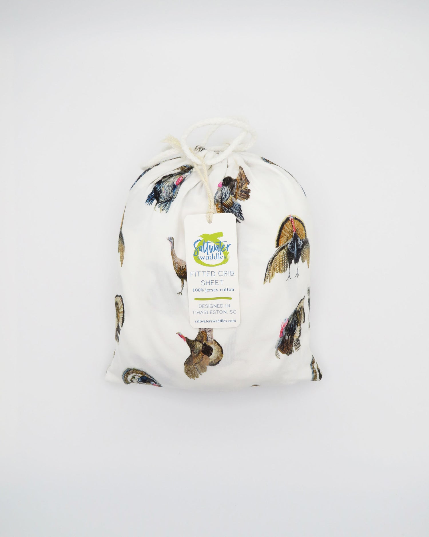 Adorable Turkey Trot crib sheet in soft white jersey cotton, featuring playful turkeys. Displayed on a white background, highlighting cozy and stylish nursery décor—perfect for a turkey-themed nursery.