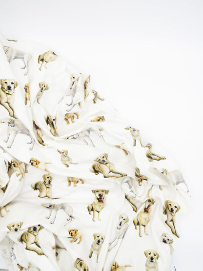 A Yellow Labs pattern swaddle displayed on a white background.