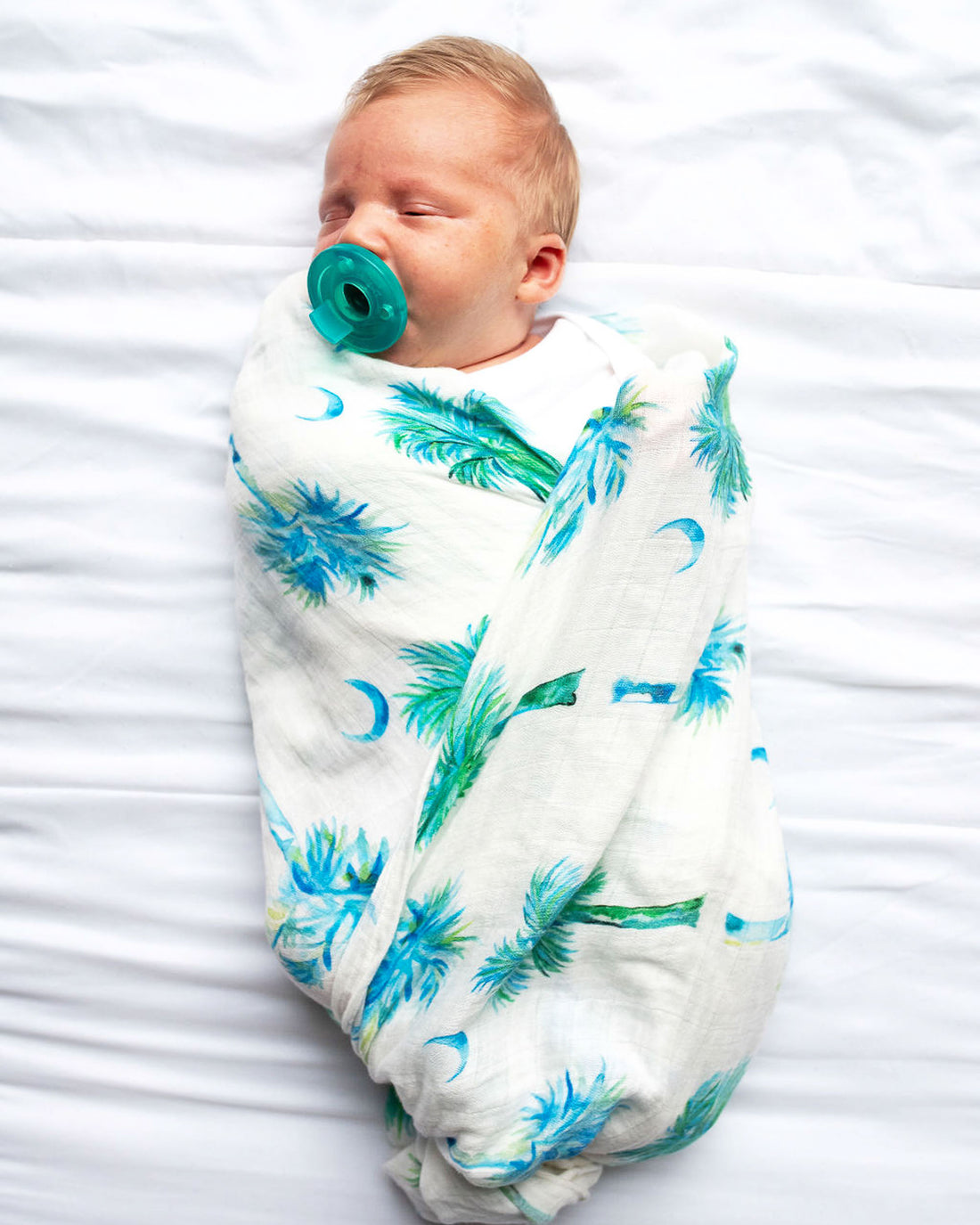 Blue Palmettos Print Baby Swaddle with Watercolor Palmetto Trees Design. blue palmettos hand-painted and printed on soft white fabric. 