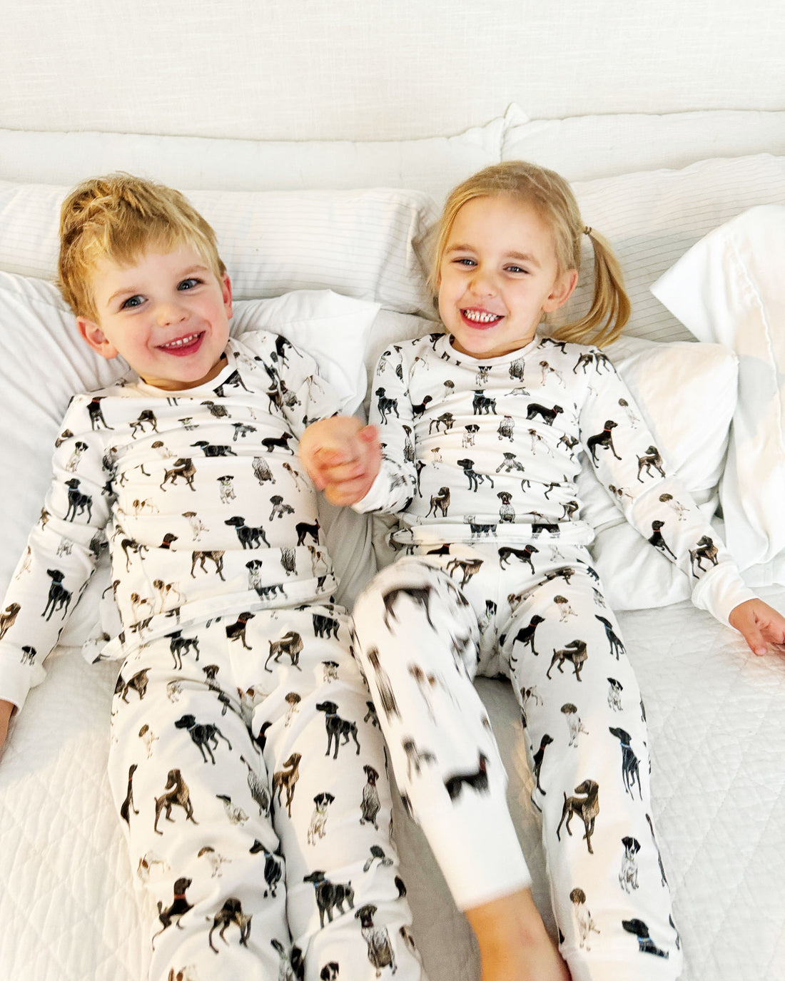 Children wearing comfy kids pajamas with German Shorthaired Pointer printed on soft white fabric