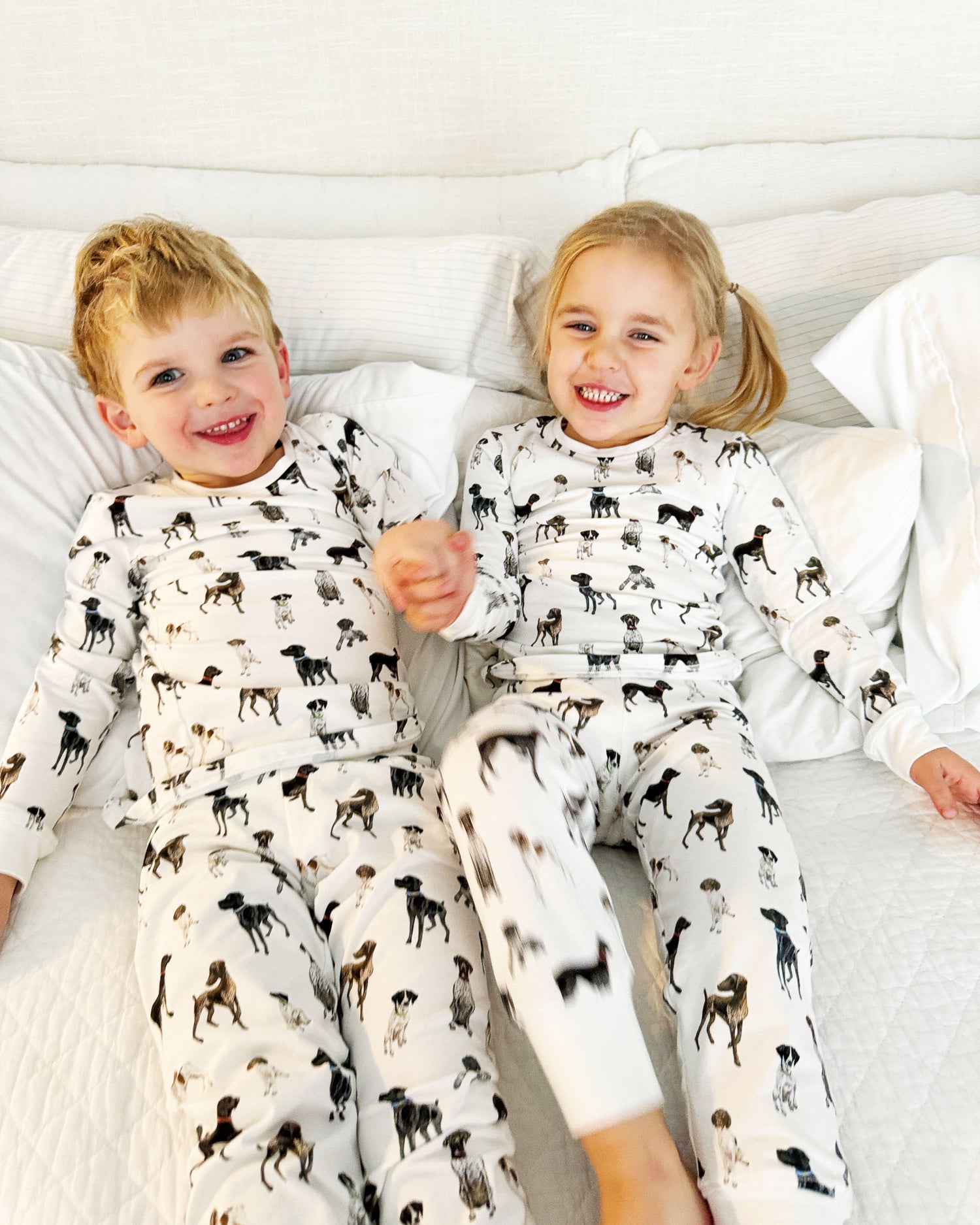 Children wearing comfy kids pajamas with German Shorthaired Pointer printed on soft white fabric