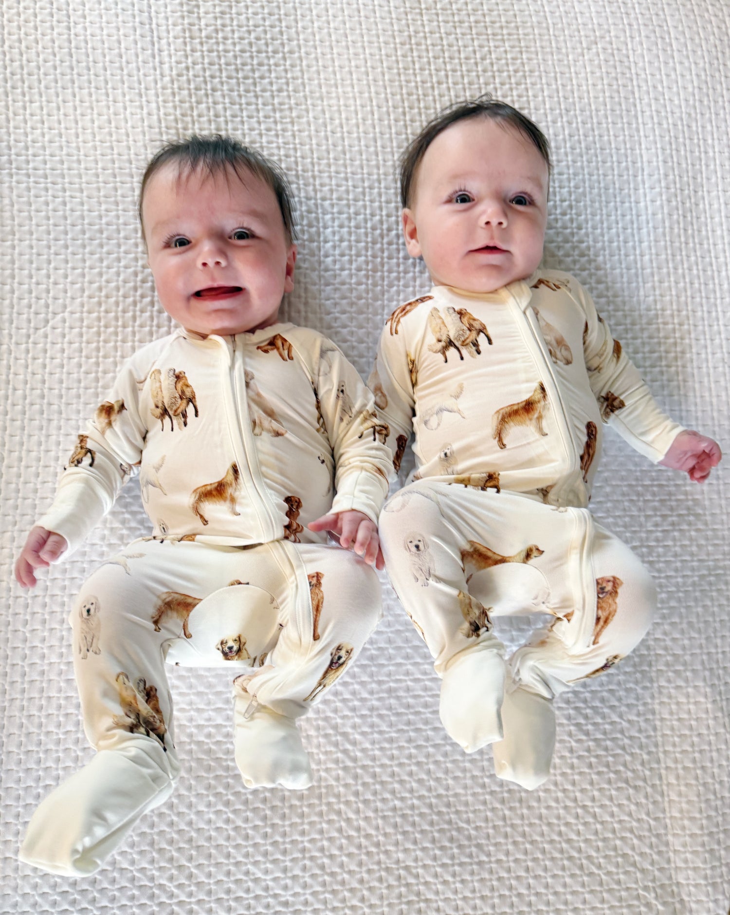 Soft white baby footie pajamas featuring a golden retriever print, with convertible feet designed for comfortable indoor and outdoor wear.