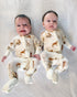 Soft white baby footie pajamas featuring a golden retriever print, with convertible feet designed for comfortable indoor and outdoor wear.
