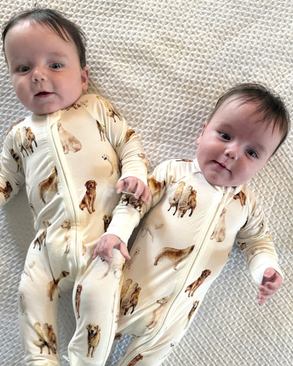 Soft white baby footie pajamas featuring a golden retriever print, with convertible feet designed for comfortable indoor and outdoor wear.