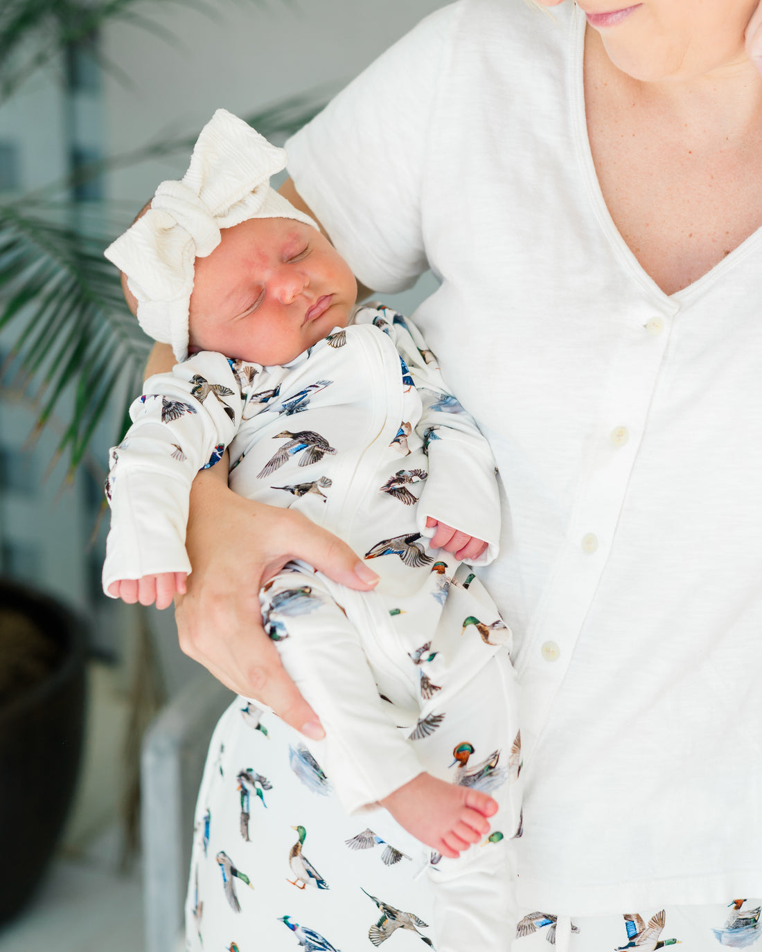 Unisex duck-print convertible zip footies for babies, designed for comfort and breathability.