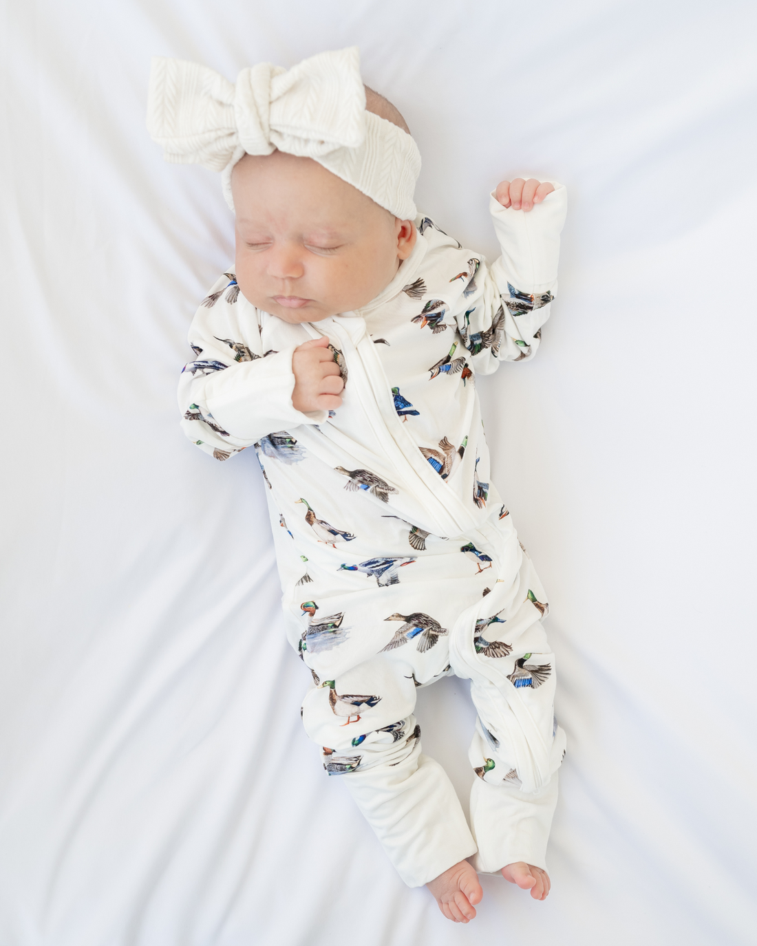 Unisex duck-print convertible zip footies for babies, designed for comfort and breathability.