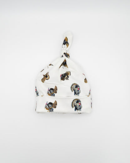 Newborn hat featuring a festive Turkey Trot print, perfect for celebrating the season