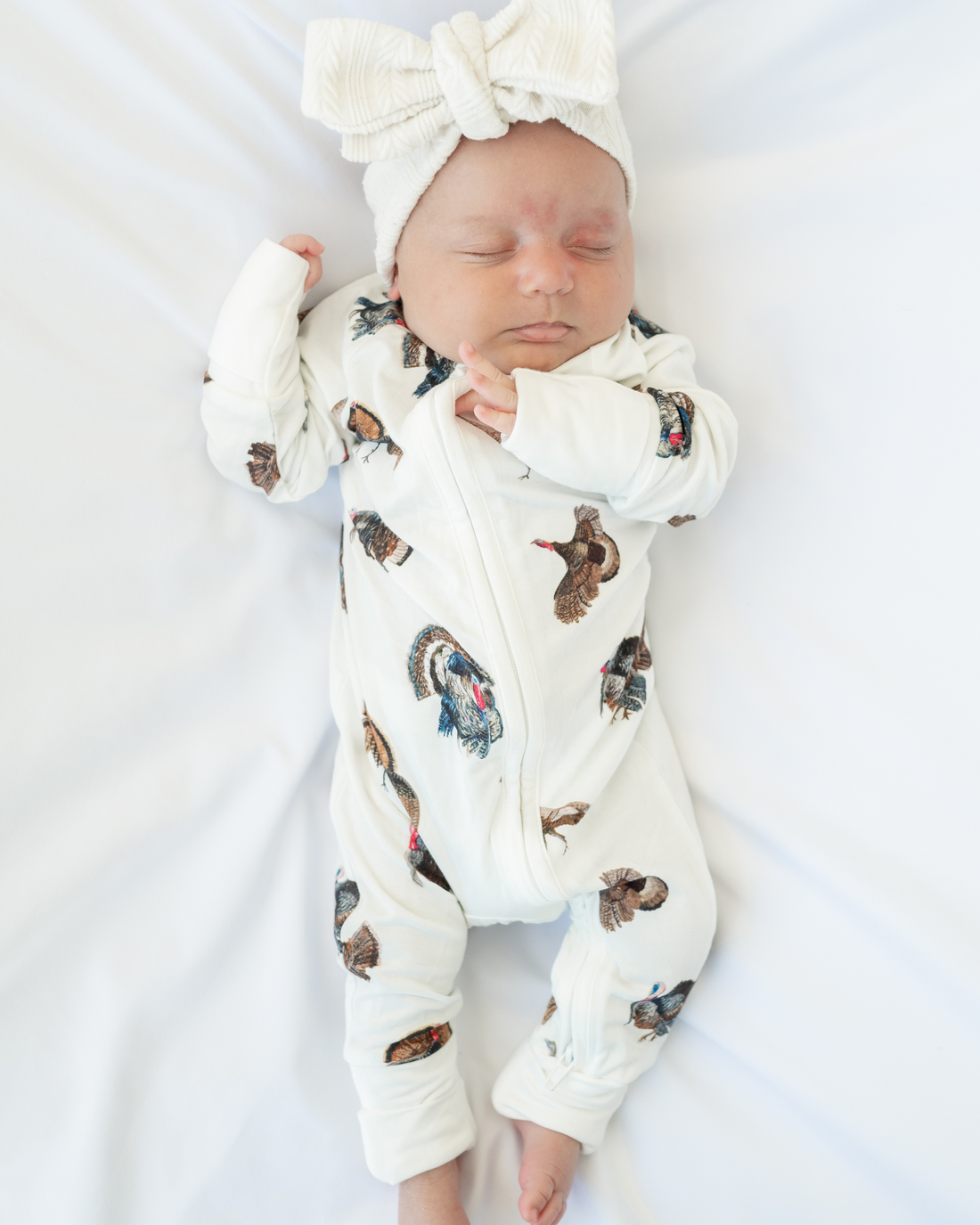 Convertible zip baby footie in festive turkey trot pattern for boys and girls.