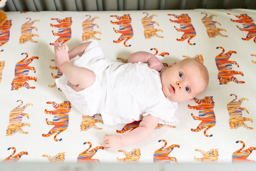 Easy Tiger crib sheet featuring a playful tiger print on soft jersey cotton fabric for baby nurseries.